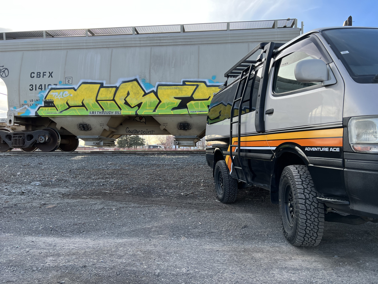 Adventure Ace van parked by rail car