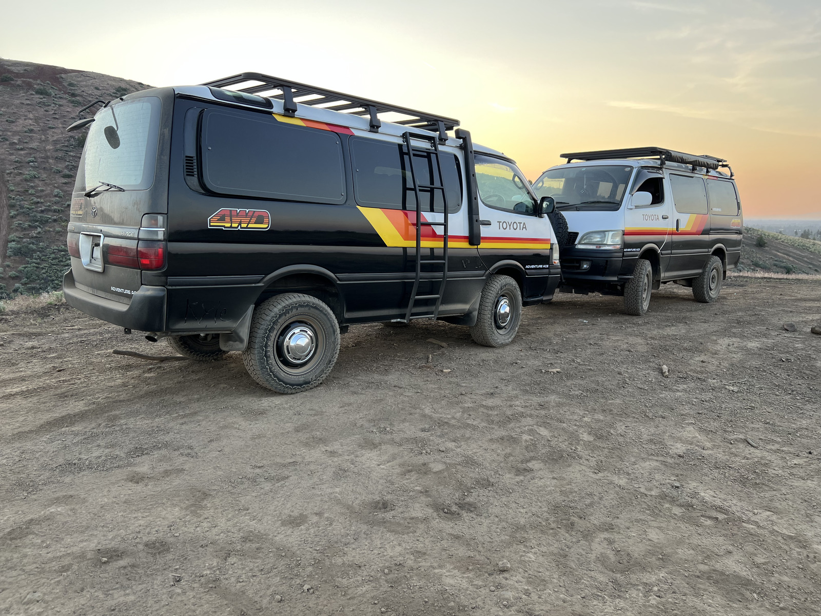 Adventure Ace vans at desert sunset